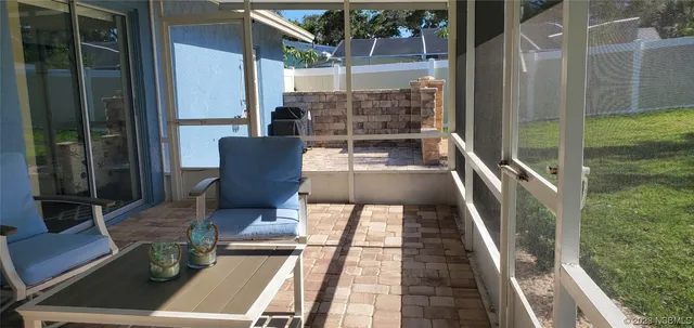 a view of balcony with two chairs and wooden floor