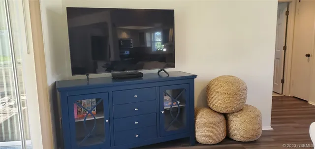 a view of hallway with mirror and wooden floor