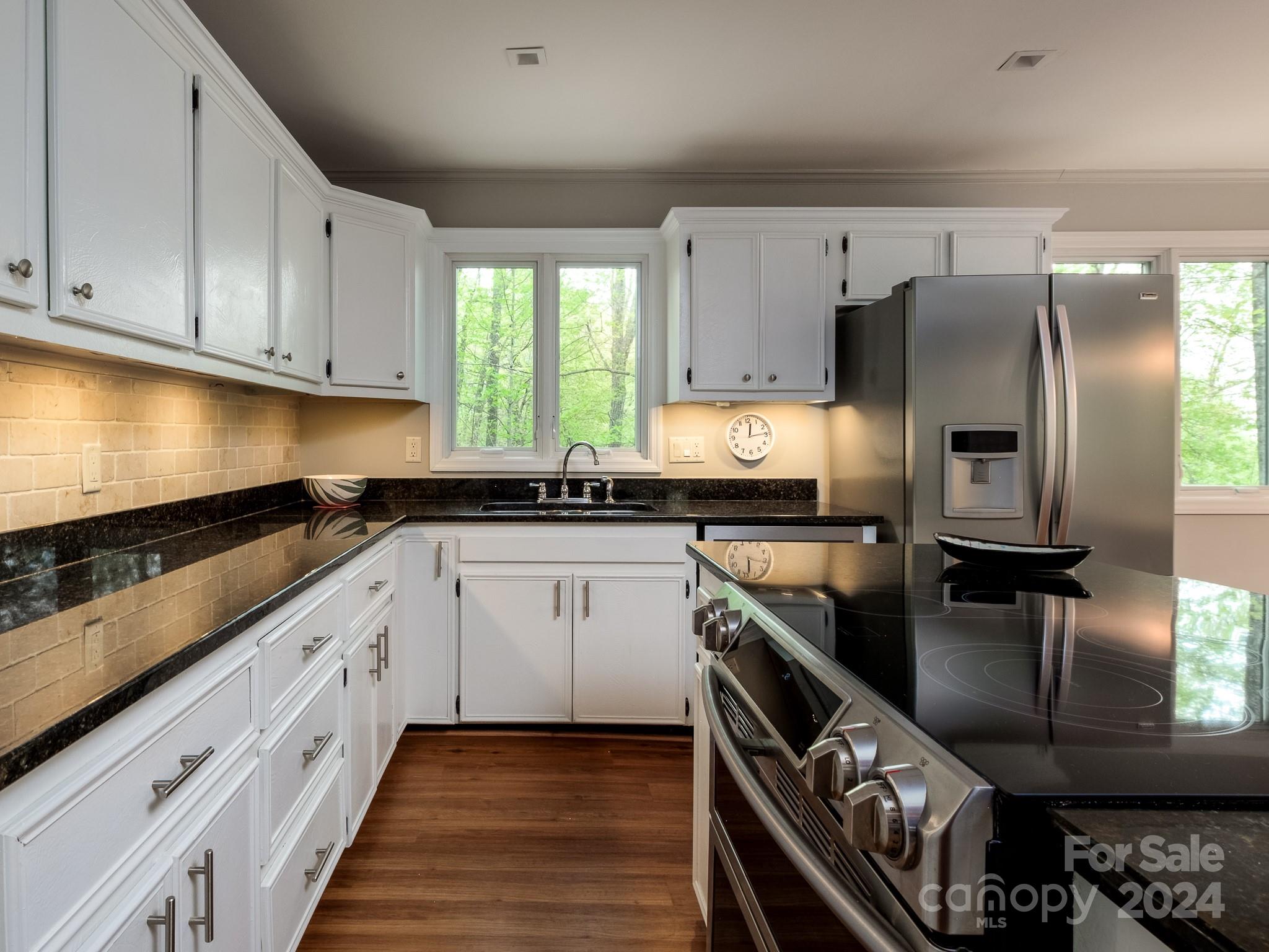 145 Catatoga Path Brevard, NC 28712 - Photo 13 of 41 a kitchen with stainless steel appliances granite countertop a sink stove and refrigerator