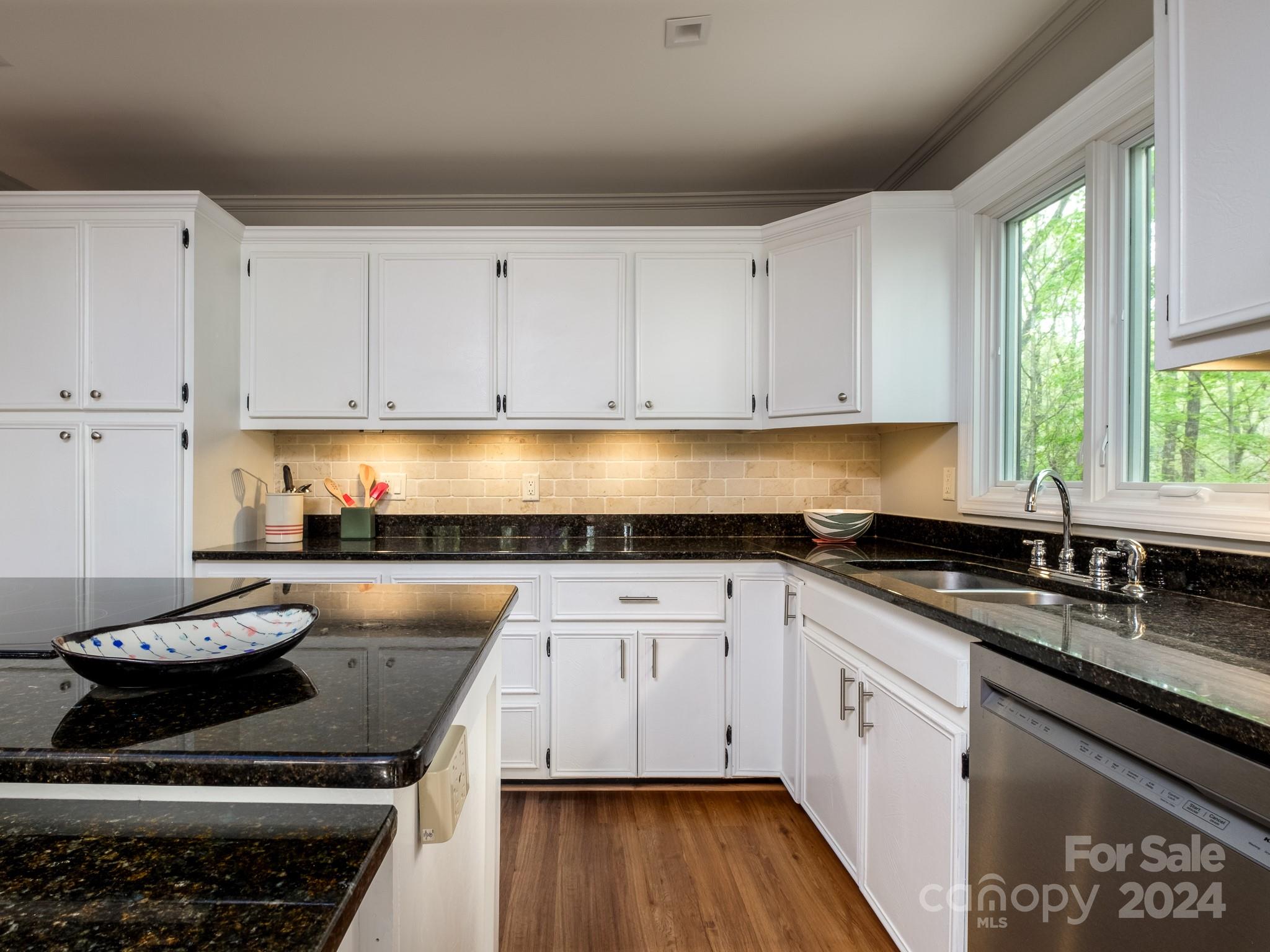 145 Catatoga Path Brevard, NC 28712 - Photo 14 of 41 a kitchen with granite countertop a sink a stove and cabinets