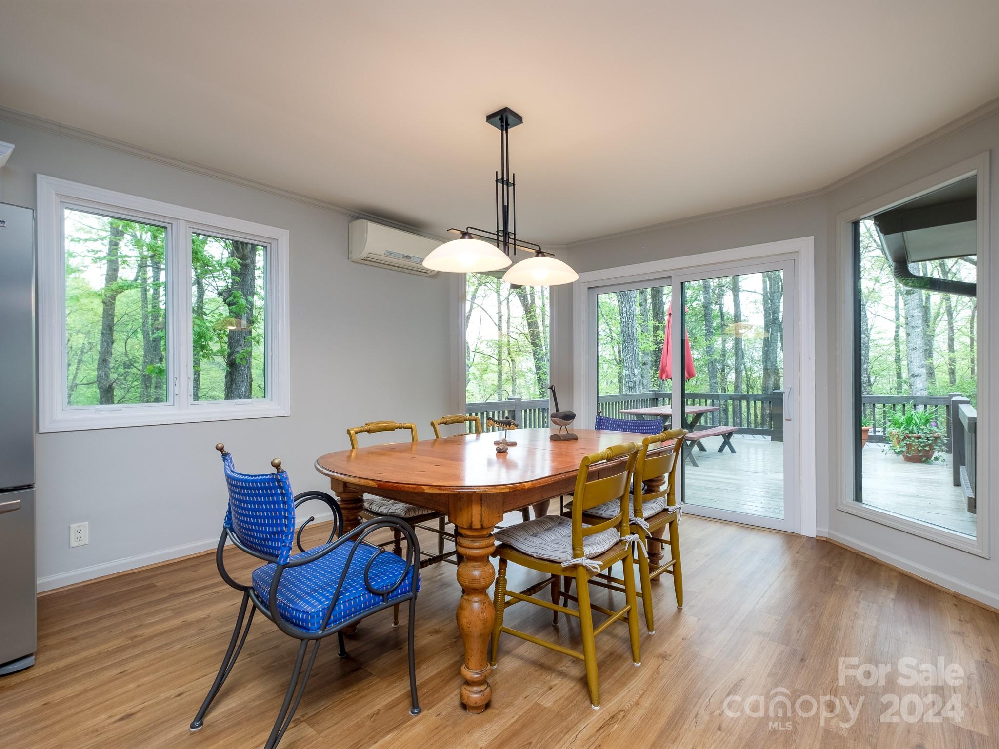 145 Catatoga Path Brevard, NC 28712 - Photo 15 of 41 a dining room with furniture a chandelier and wooden floor