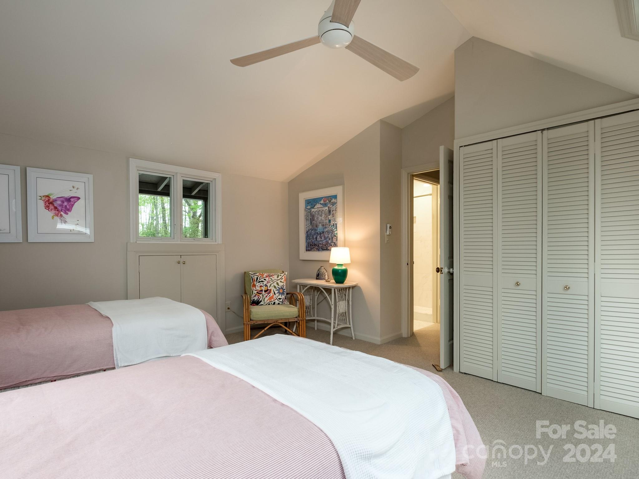 145 Catatoga Path Brevard, NC 28712 - Photo 33 of 41 a bedroom with a bed and a chandelier