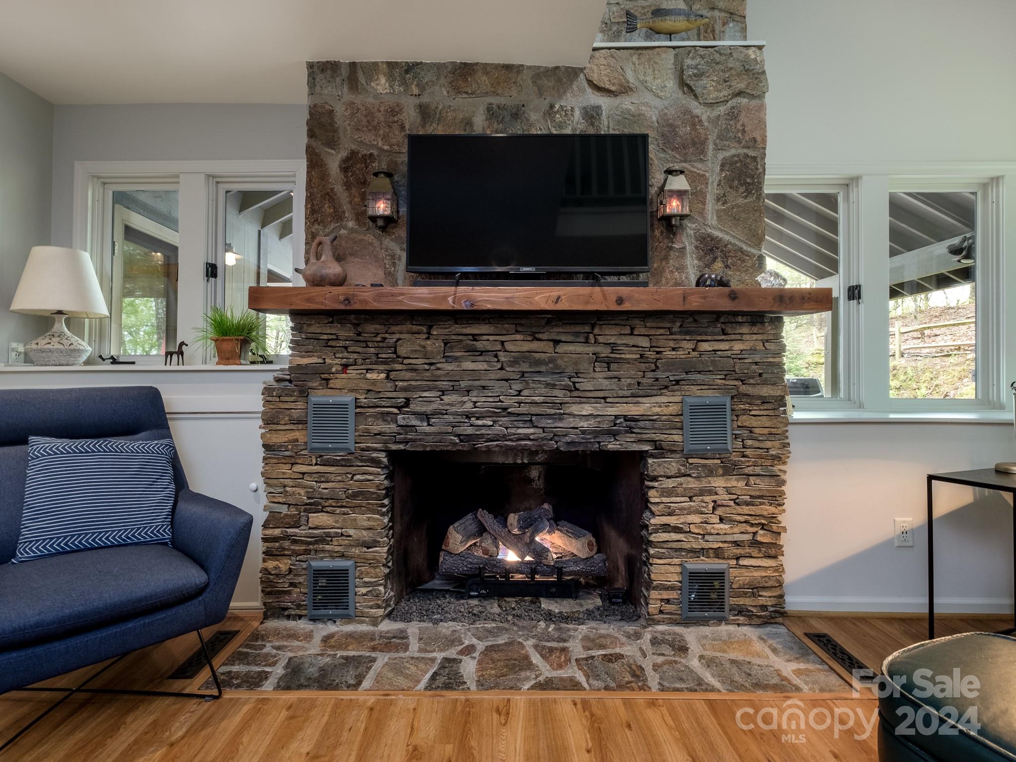 145 Catatoga Path Brevard, NC 28712 - Photo 10 of 41 a living room with a fireplace a flat screen tv and a fireplace