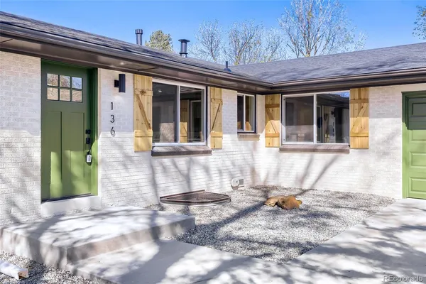 a view of a brick house with large windows