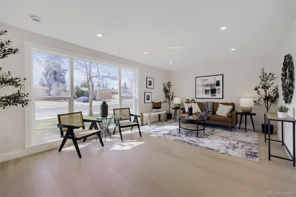 a living room with furniture a rug and a window
