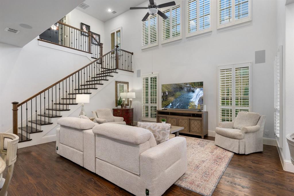 531 Sandy Lane Flower Mound, TX 75022 - Photo 14 of 32 Two-story living area hardwood flooring, a grand staircase