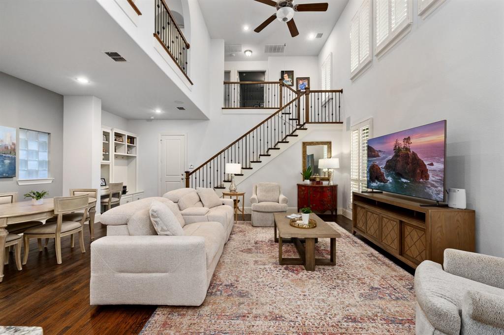 531 Sandy Lane Flower Mound, TX 75022 - Photo 17 of 32 Spacious living area featuring a two-story ceiling, recessed lighting, and wood-finish flooring