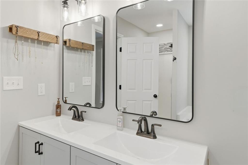 302 White Marble Way Ball Ground, GA 30107 - Photo 15 of 28 a bathroom with a sink and mirror