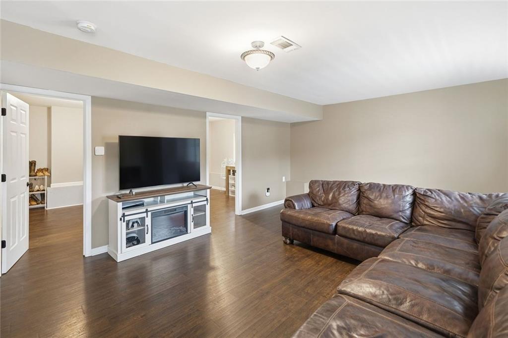 302 White Marble Way Ball Ground, GA 30107 - Photo 18 of 28 a living room with furniture and a flat screen tv