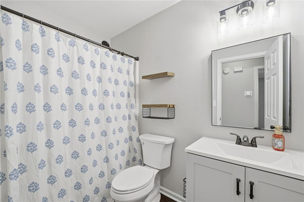 302 White Marble Way Ball Ground, GA 30107 - Photo 23 of 28 a bathroom with a sink and a mirror