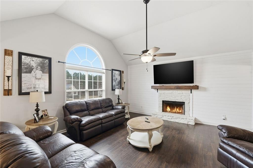 302 White Marble Way Ball Ground, GA 30107 - Photo 4 of 28 a living room with furniture a flat screen tv and a fireplace