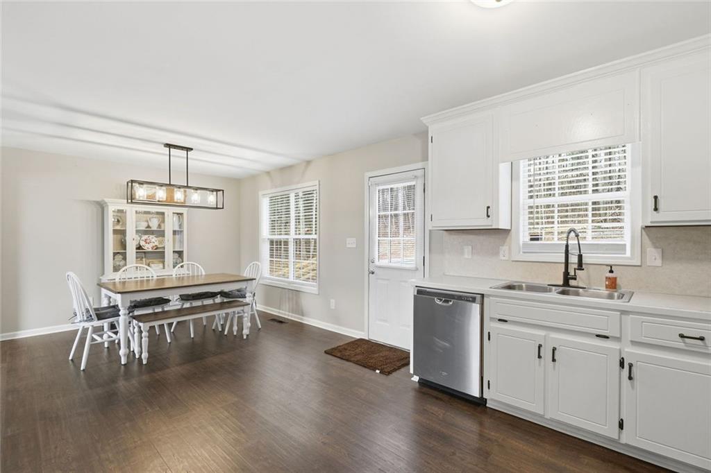 302 White Marble Way Ball Ground, GA 30107 - Photo 8 of 28 a kitchen with a sink stove and cabinets