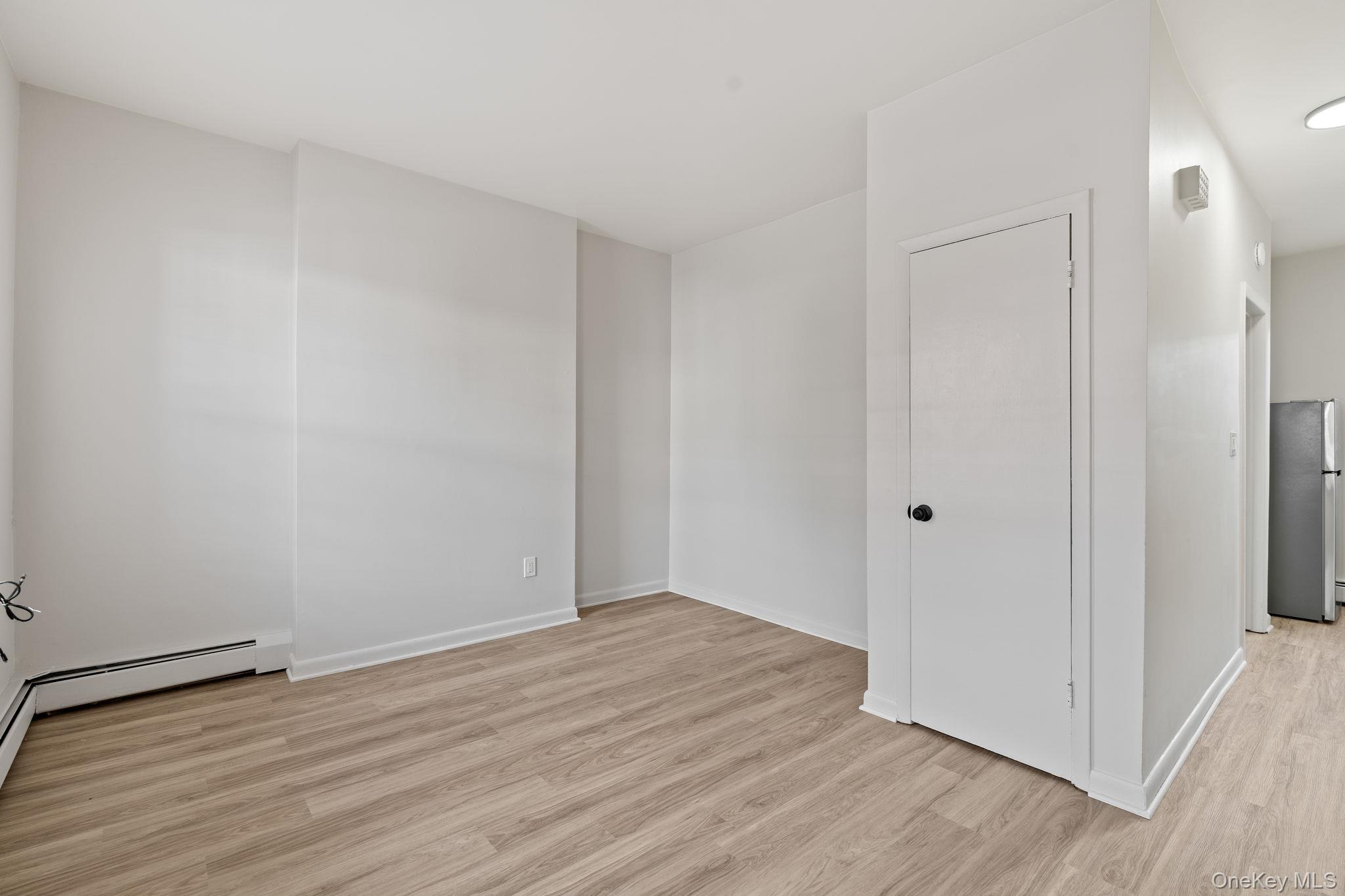 32 North Bridge Street Poughkeepsie, NY 12601 - Photo 5 of 19 a view of an empty room with wooden floor and a window