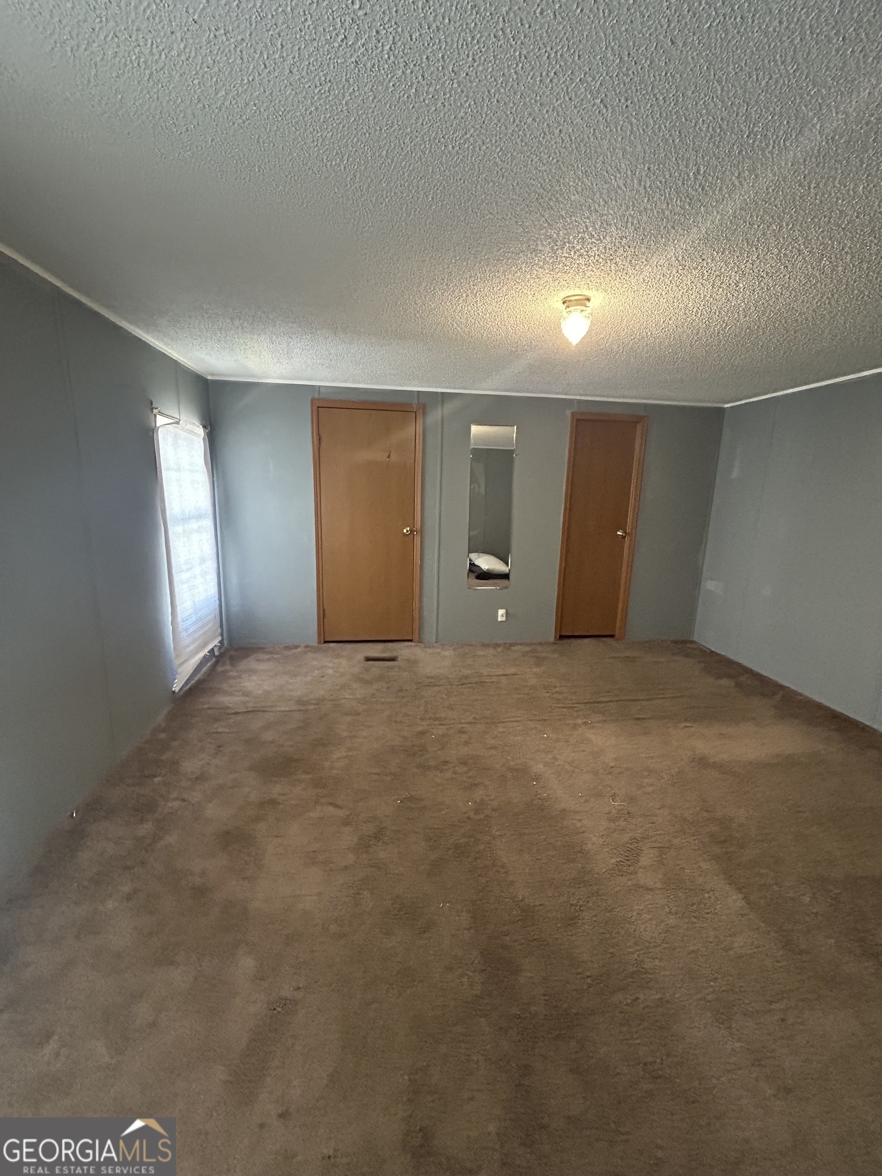 269 Lakeview Drive Locust Grove, GA 30248 - Photo 9 of 13 an empty room with windows and closet