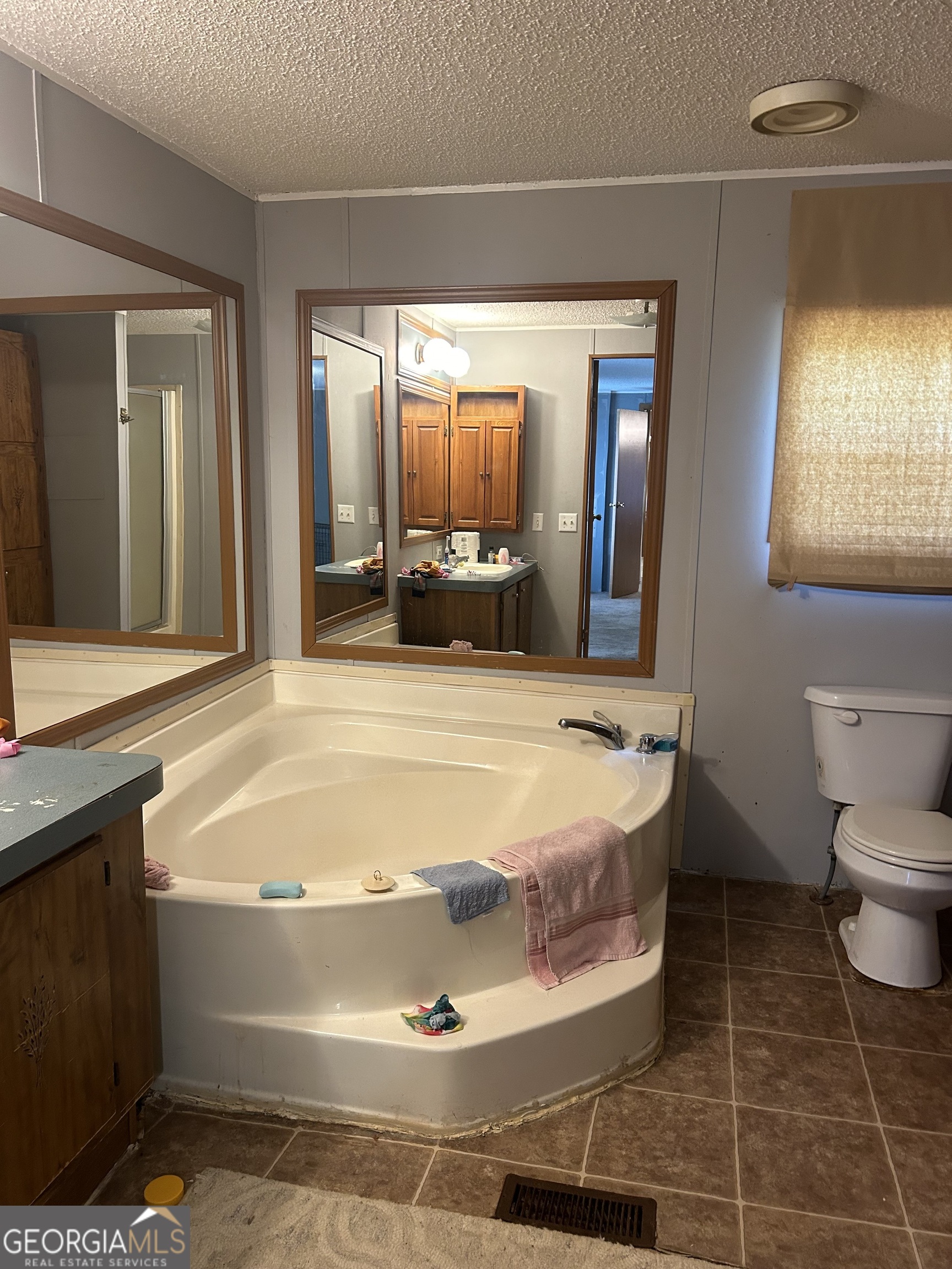 269 Lakeview Drive Locust Grove, GA 30248 - Photo 10 of 13 a bed sitting in a bedroom next to a window