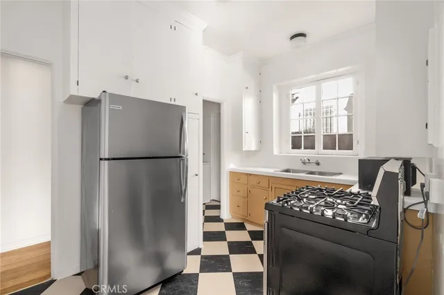 a kitchen with stainless steel appliances granite countertop a refrigerator and a sink