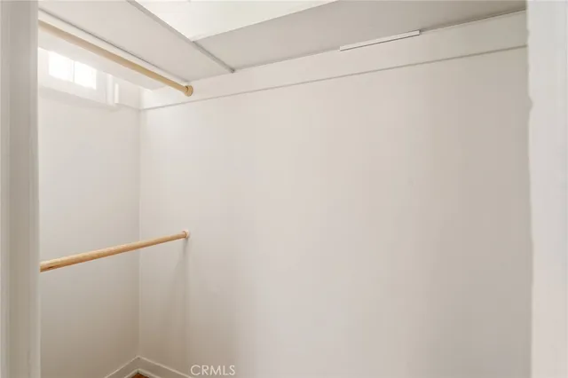 a view of a big room with wooden floor and a ceiling fan