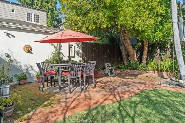 a view of a backyard with a patio and fire pit