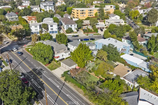 an aerial view of residential houses with city view