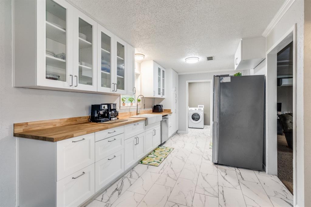 109 North Ash Avenue Azle, TX 76020 - Photo 14 of 25 a kitchen with stainless steel appliances granite countertop a refrigerator and a sink