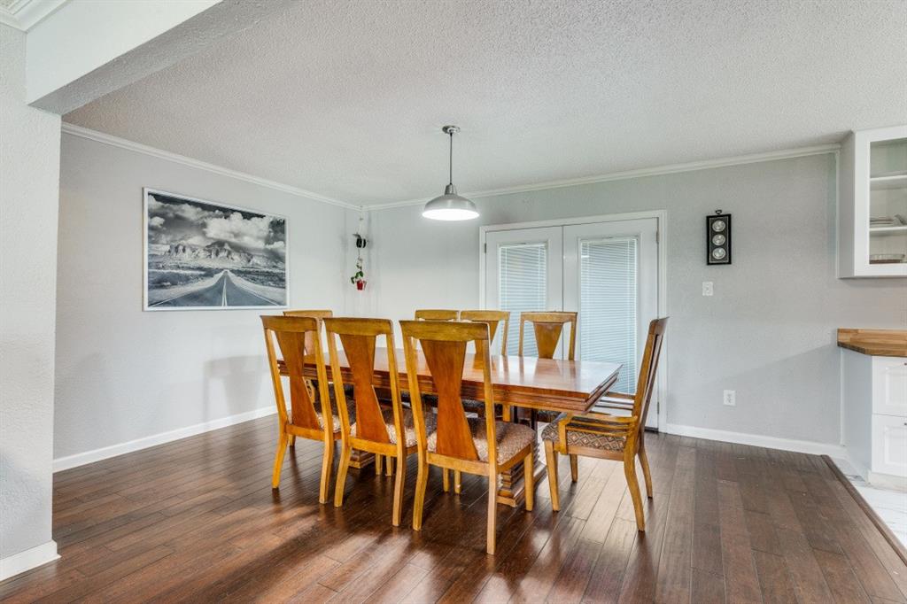 109 North Ash Avenue Azle, TX 76020 - Photo 16 of 25 a view of a dining room with furniture and wooden floor