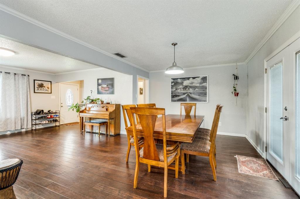 109 North Ash Avenue Azle, TX 76020 - Photo 18 of 25 a view of a dining room with furniture window and wooden floor
