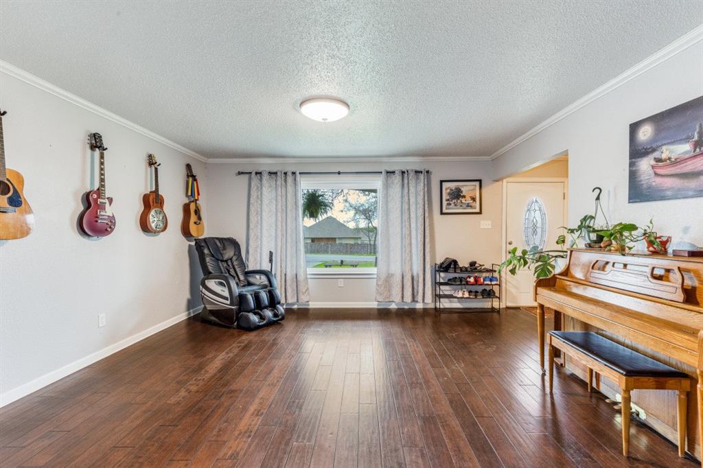 109 North Ash Avenue Azle, TX 76020 - Photo 20 of 25 a view of a livingroom with furniture hardwood floor and a window