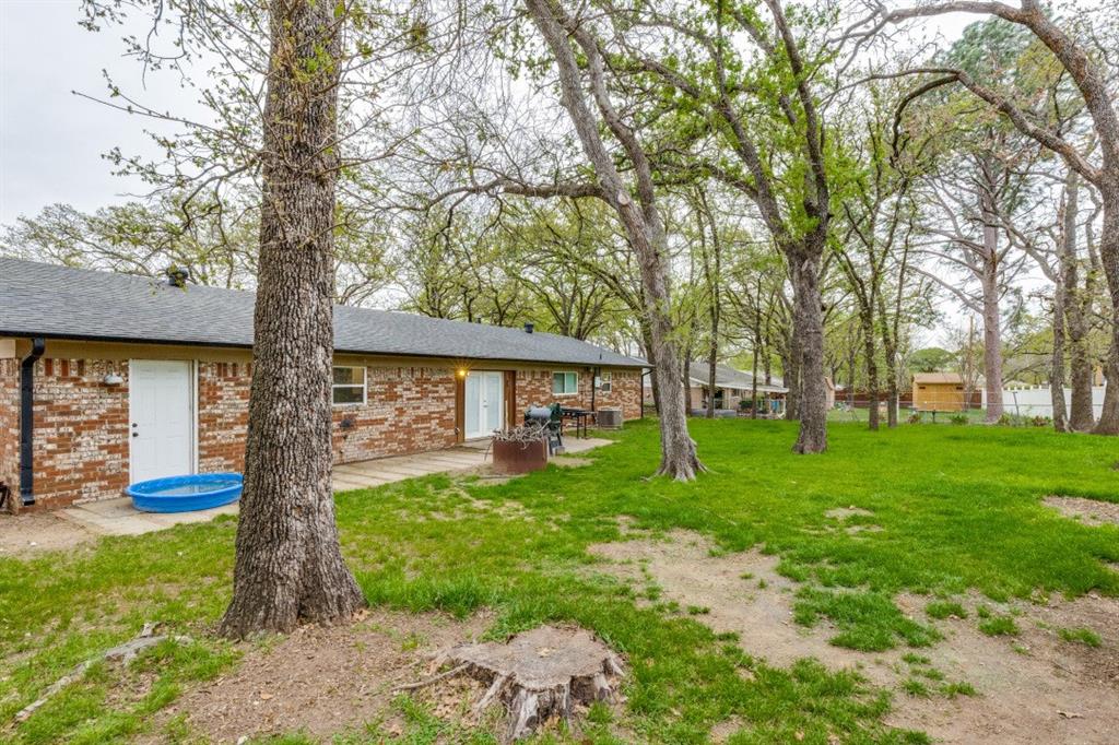 109 North Ash Avenue Azle, TX 76020 - Photo 23 of 25 a front view of a house with garden