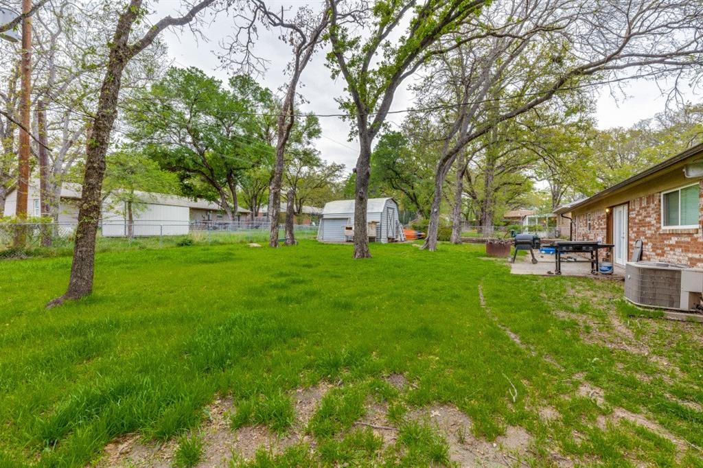 109 North Ash Avenue Azle, TX 76020 - Photo 24 of 25 a view of a house with a backyard