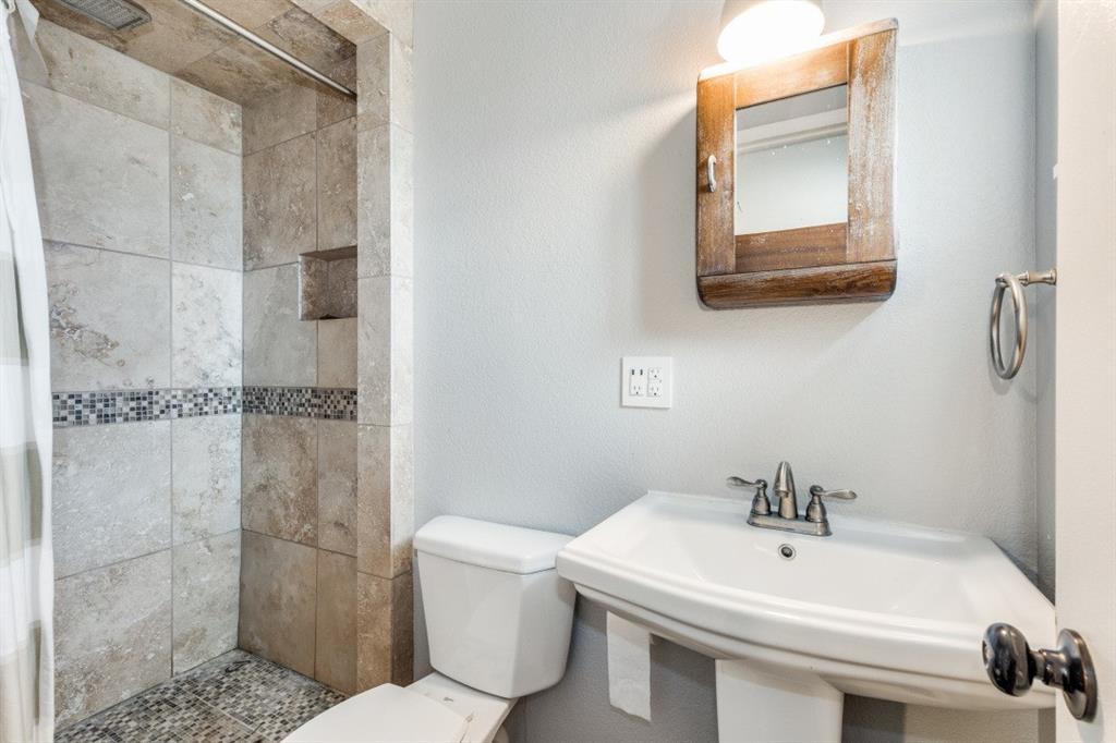 109 North Ash Avenue Azle, TX 76020 - Photo 4 of 25 a bathroom with a sink a toilet and shower