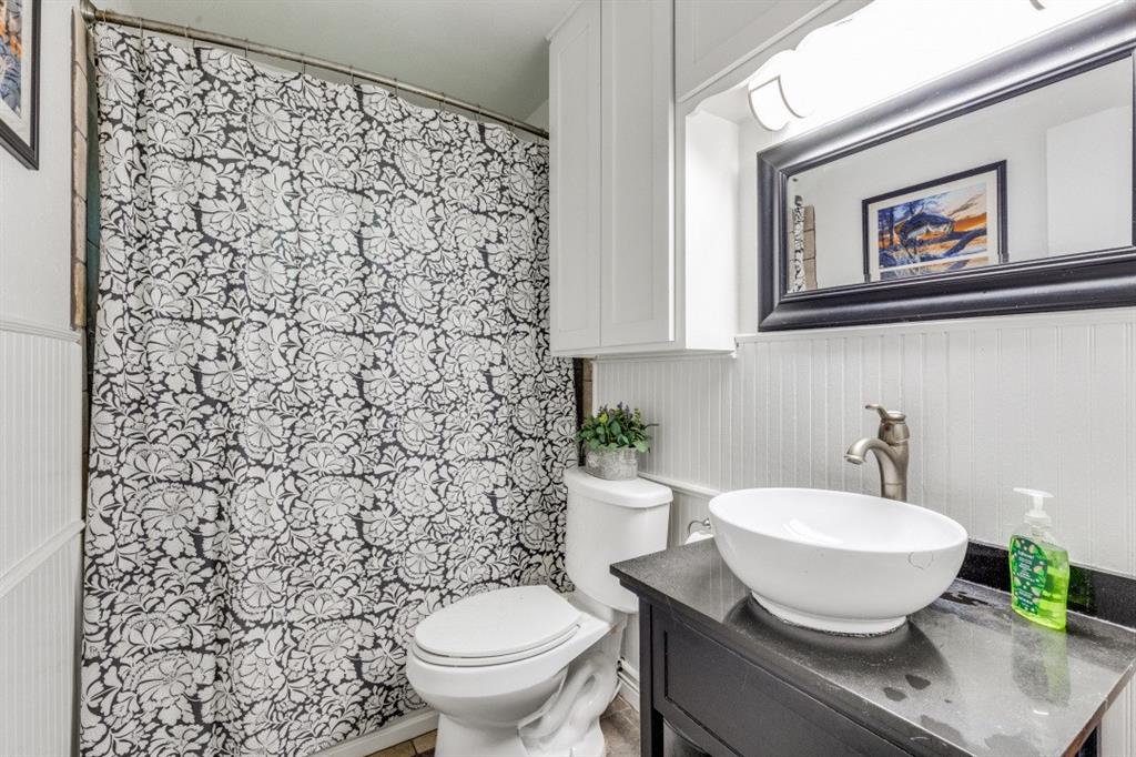 109 North Ash Avenue Azle, TX 76020 - Photo 8 of 25 a bathroom with a sink toilet and a mirror