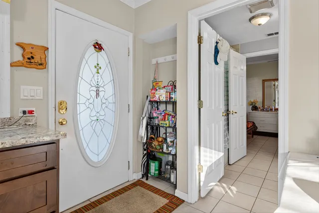 a living room with furniture and kitchen view