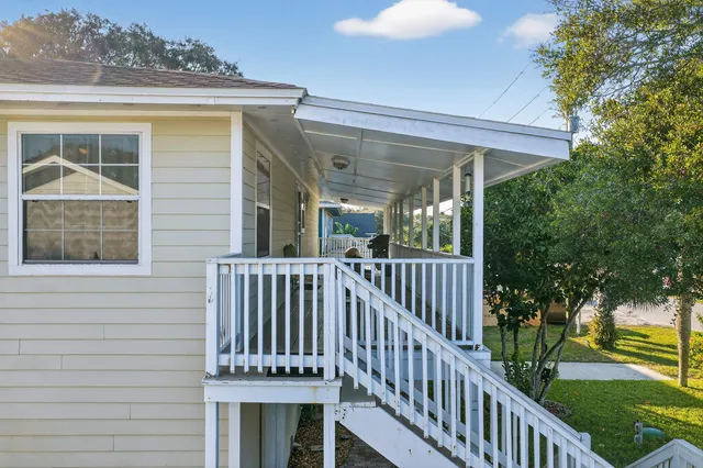 a kitchen with stainless steel appliances granite countertop a table and chairs in it