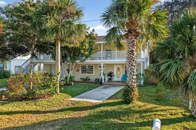 a living room with furniture and potted plants