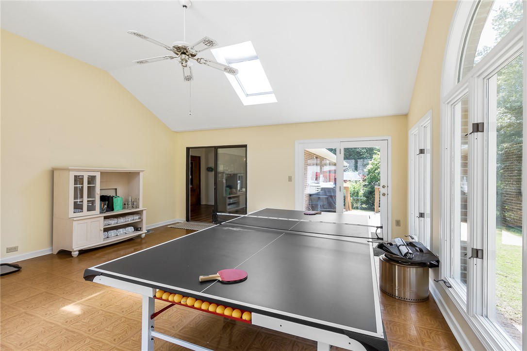 207 Laurel Ridge Road Anderson, SC 29621 - Photo 23 of 50 A well-lit recreational space boasts vaulted ceilings, a skylight, and direct outdoor access through glass doors.