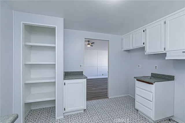 a kitchen with white cabinets and a sink