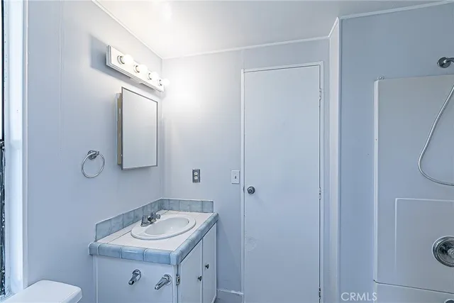 a bathroom with a sink toilet and a mirror