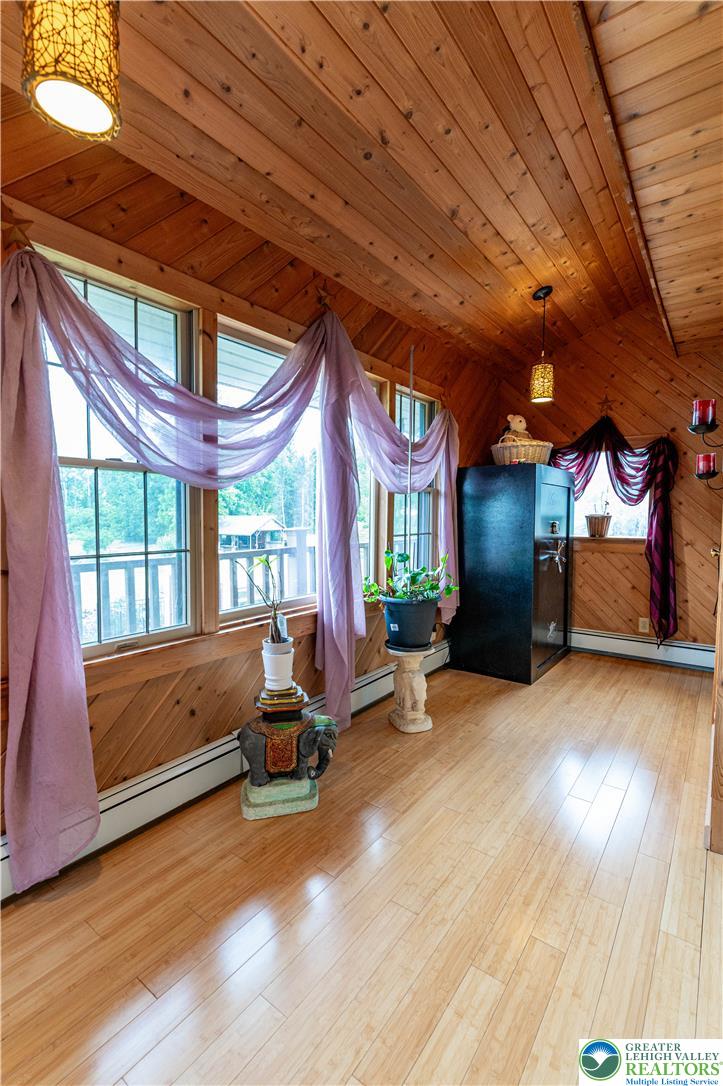 2485 Hieter Road Quakertown, PA 18951 - Photo 35 of 97 Natural wood paneling and bright windows define this inviting room, offering tranquil views and an open atmosphere.
