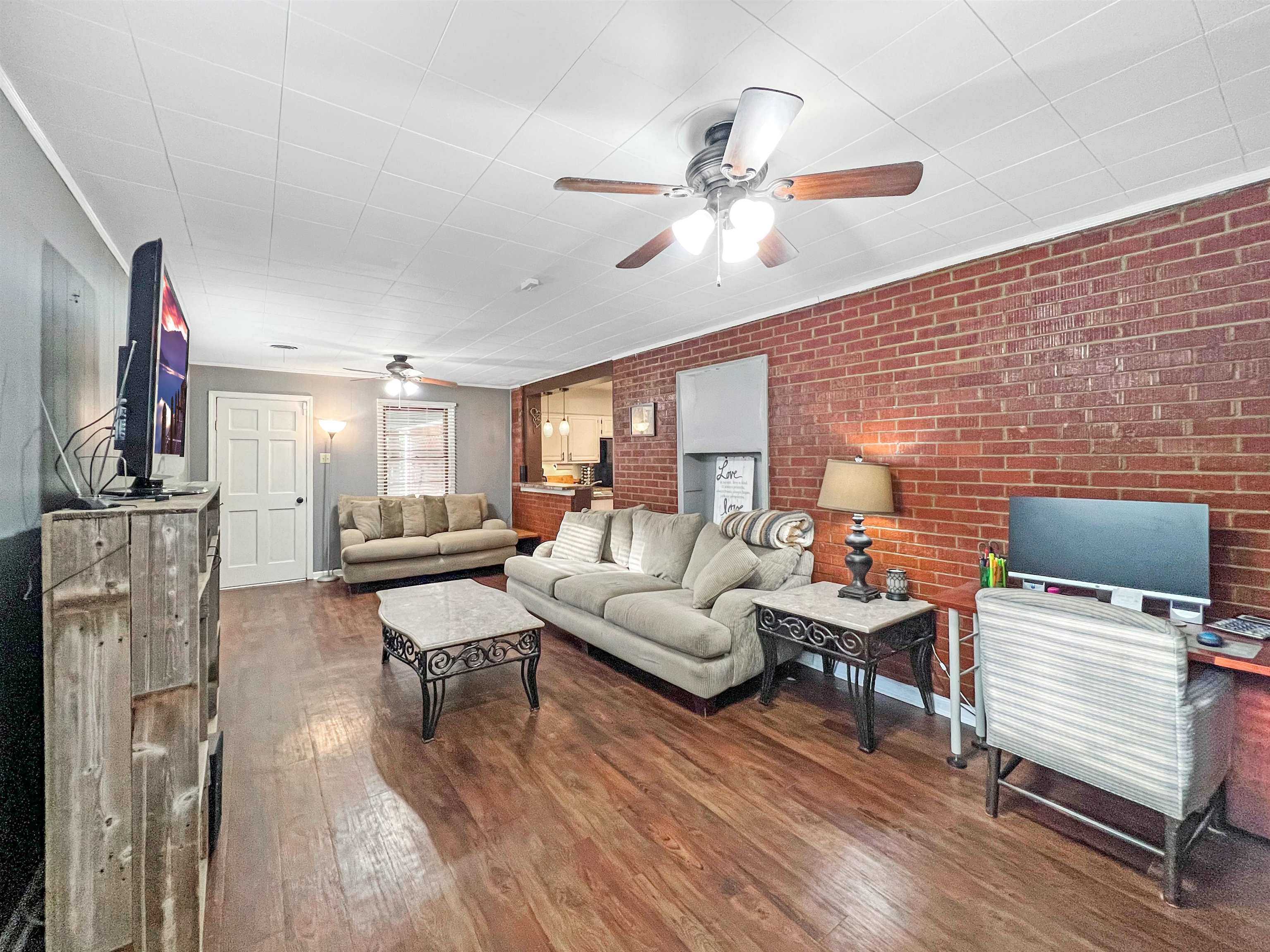 1396 Whitewater Road Memphis, TN 38117 - Photo 13 of 25 a living room with furniture a rug and a flat screen tv