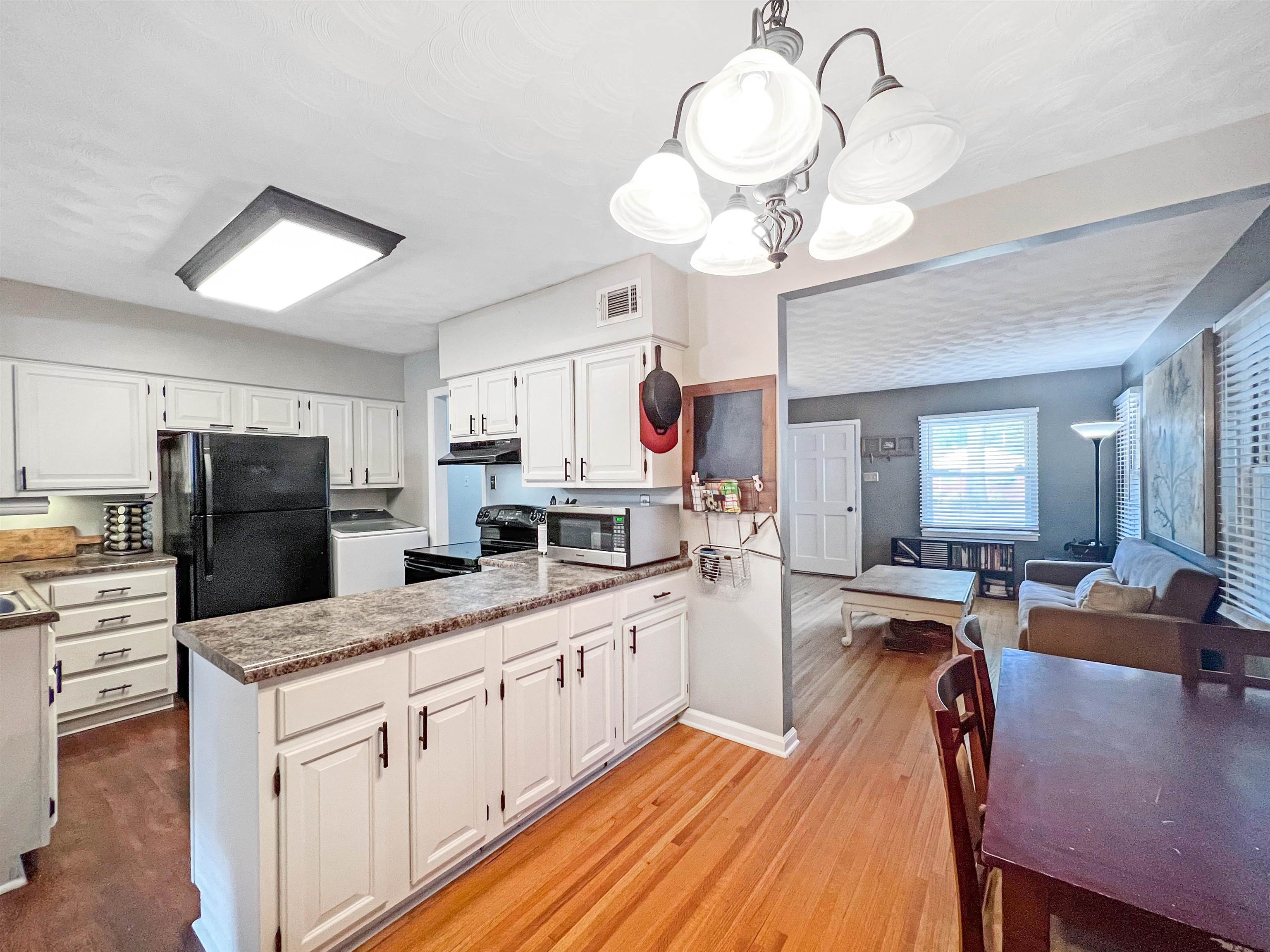 1396 Whitewater Road Memphis, TN 38117 - Photo 6 of 25 a kitchen with stainless steel appliances kitchen island granite countertop a stove refrigerator and cabinets