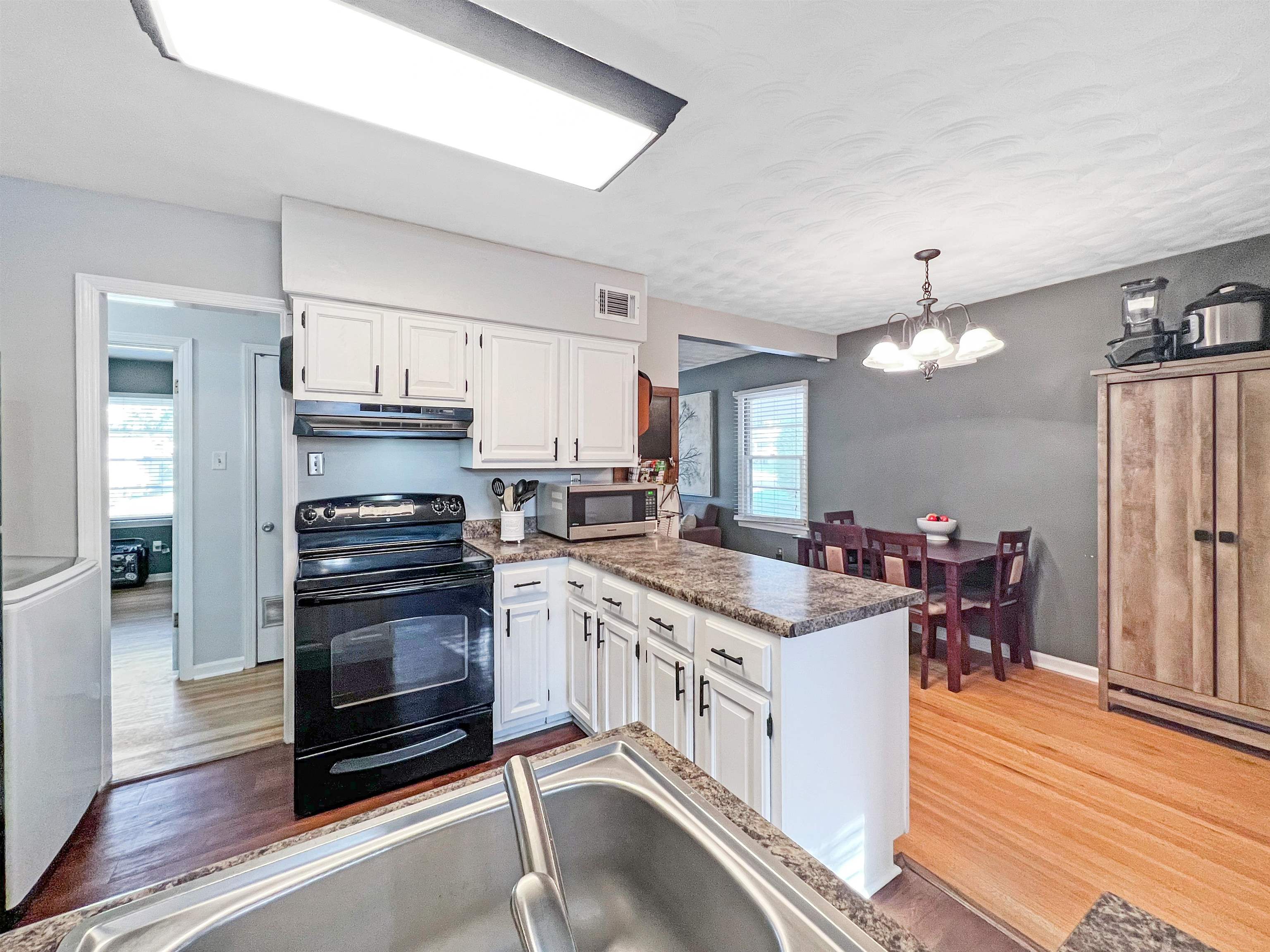 1396 Whitewater Road Memphis, TN 38117 - Photo 8 of 25 a kitchen with a stove a sink and a refrigerator