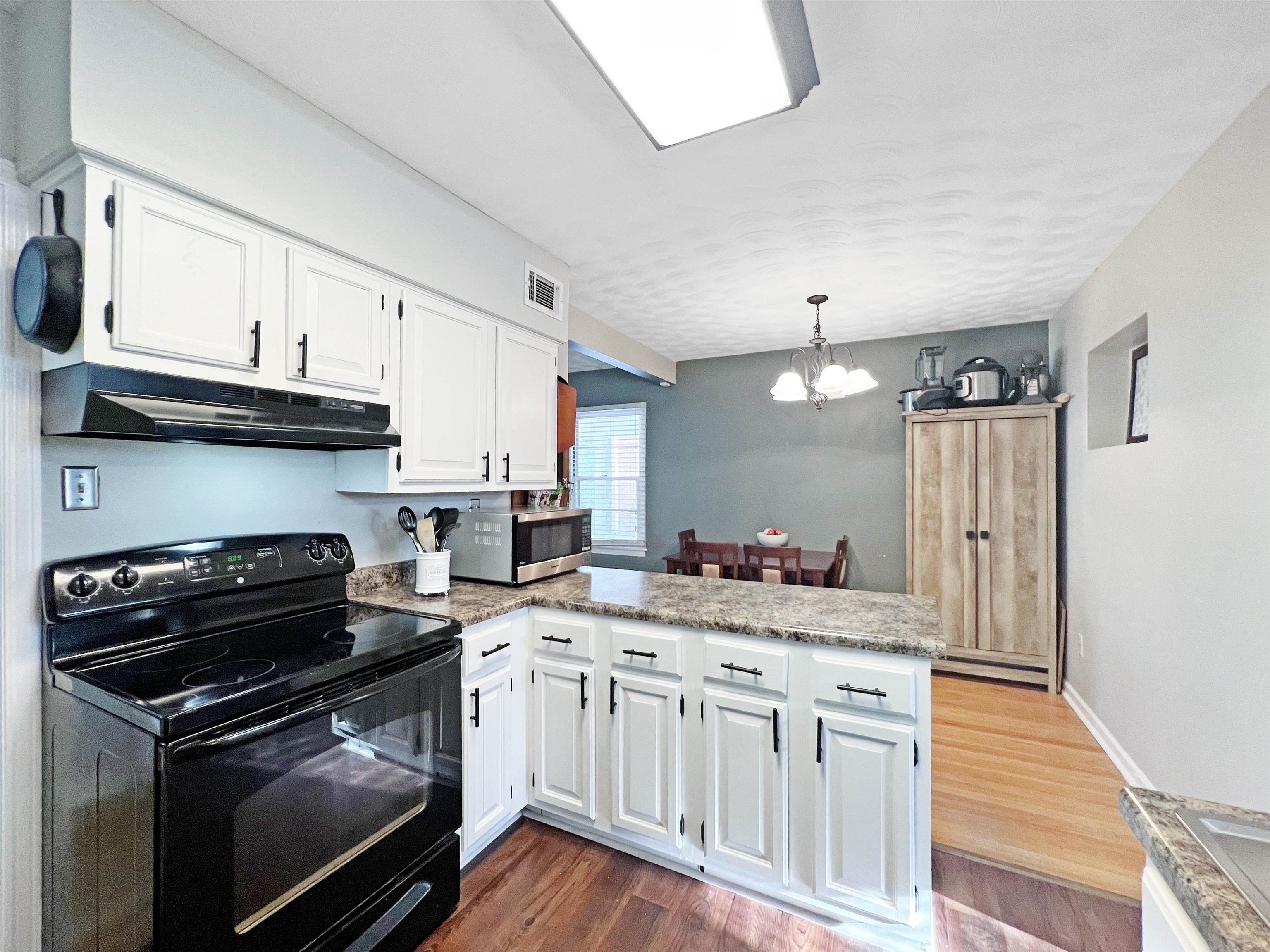 1396 Whitewater Road Memphis, TN 38117 - Photo 9 of 25 a kitchen with granite countertop a stove sink and cabinets