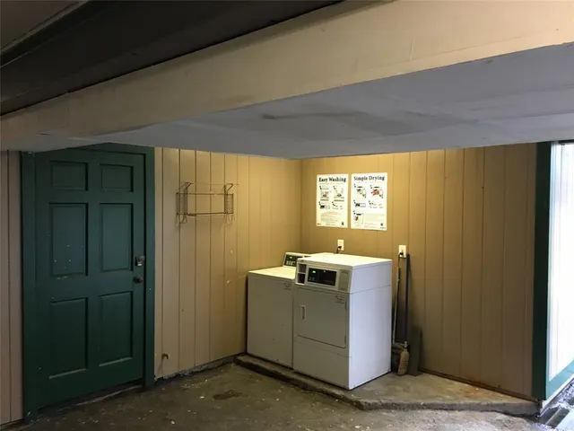 a view of a kitchen with wooden floor and windows