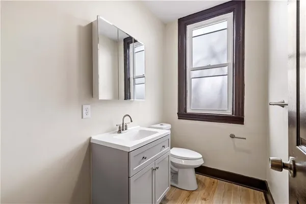 a bathroom with a toilet sink and mirror