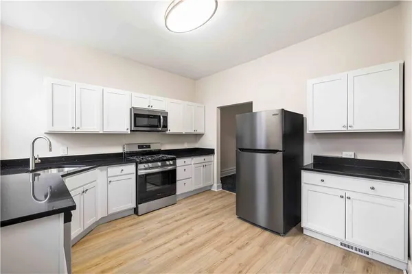 a kitchen with a refrigerator sink and microwave