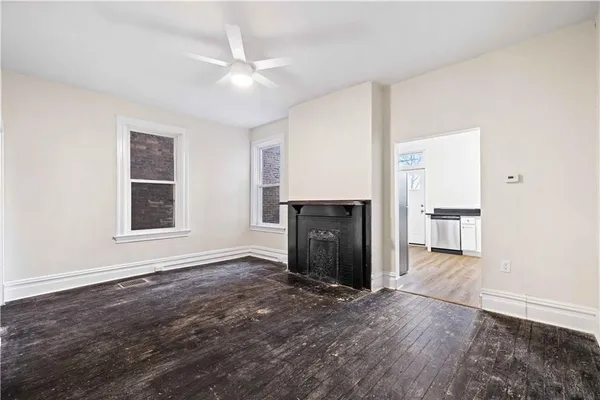 an empty room with windows and entrance