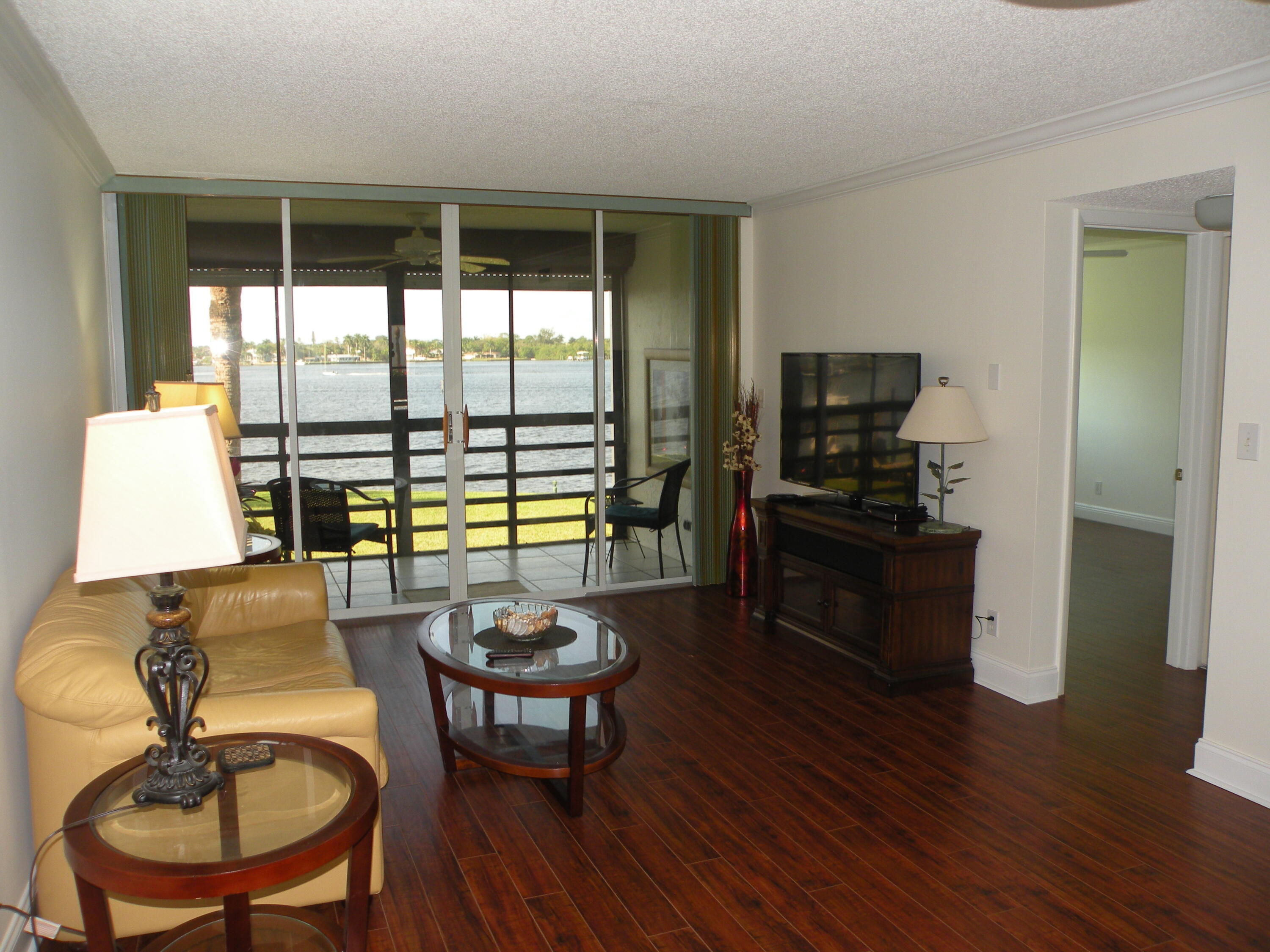 1950 Southwest Palm City Road Southwest, Unit 13203 Stuart, FL 34994 - Photo 20 of 29 Living Room To Porch
