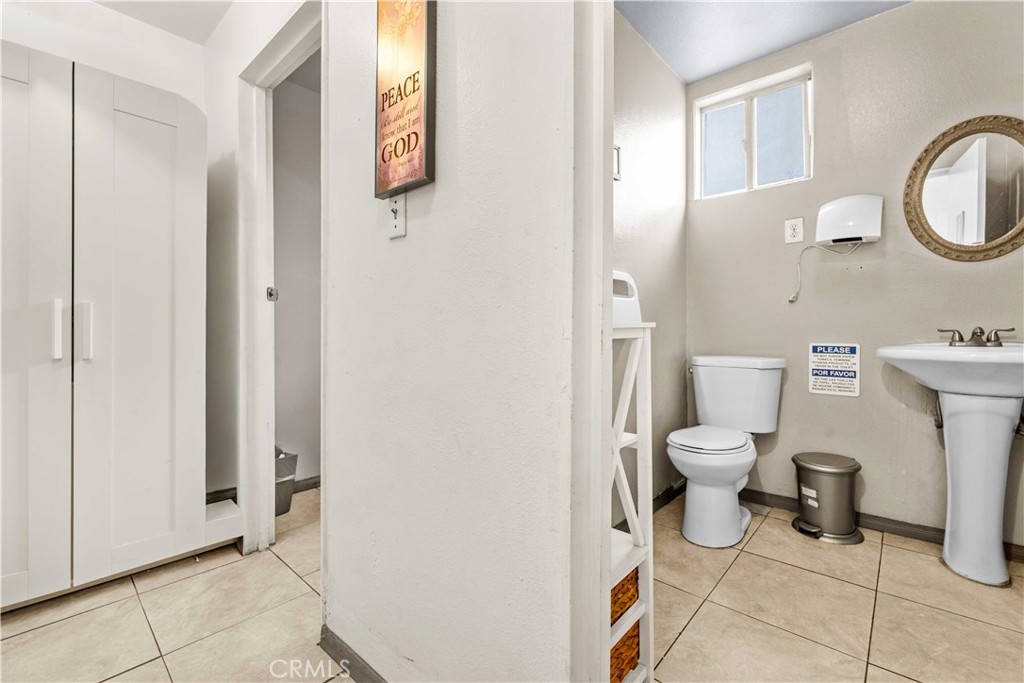 17606 Arrow Fontana, CA 92335 - Photo 29 of 30 a white toilet sitting next to a bathroom sink