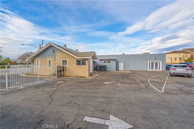 a view of a house with a patio and a yard