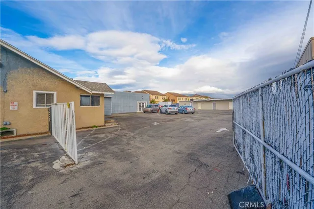 a view of a house with wooden fence